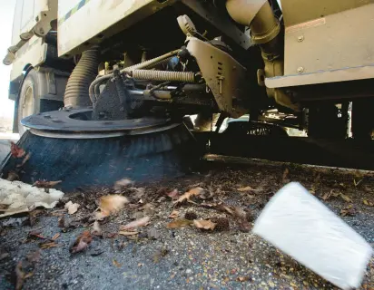  ?? BILL TIERNAN/FREELANCE ?? A street sweeper from Sweeping Corporatio­n of America works along the curb of a street Wednesday morning in the Chimney Hill section of Virginia Beach.