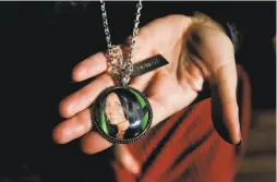 ?? Scott Mcintyre / New York Times ?? Kimberlin Nickles shows a locket with a photograph of daughter Chasity Glisson, who died after leaving her Lexus running in her garage.