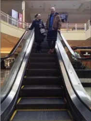  ?? THE ASSOCIATED PRESS ?? Courtney Taylor and her boyfriend, Zach Tobias, ride the escalator Friday at a mall in Whitehall, Pa.