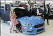  ?? CHUCK BURTON — THE ASSOCIATED PRESS ?? NASCAR driver Matt Kenseth, center, gets helps from his family as they unveil the car he will drive this season during a news conference in Charlotte, N.C. Wednesday.