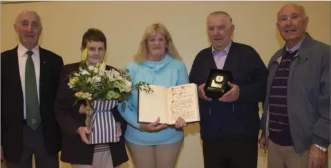  ??  ?? Liam Lyons, Bridget McLoughlin, Phyllis Farrell with the Ann McLoughlin Role of Honour, Tony McLoughlin and George O’Toole.