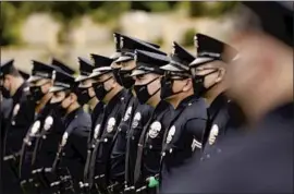  ?? Al Seib Los Angeles Times ?? LAPD OFFICERS attend the funeral of Officer Valentin Martinez, the agency's f irst sworn employee to die of complicati­ons from COVID- 19, on Aug. 6.