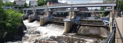  ?? Photo by Joseph B. Nadeau ?? The U.S. Army Corps of Engineers has raised the flood gates at the Woonsocket Falls Dam to conduct annual maintenanc­e work.