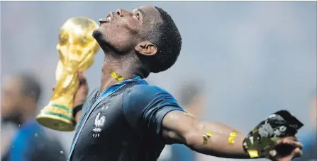  ?? NATACHA PISARENKO THE ASSOCIATED PRESS ?? France’s Paul Pogba celebrates with the trophy after winning the World Cup final, 4-2, over Croatia.