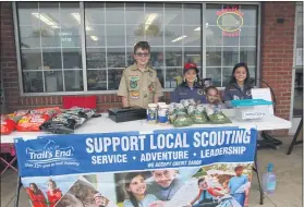  ?? JEN SAMUEL— MEDIANEWS GROUP ?? Scouts from Pack 60, including Jaxson Taylor and twin sisters Ally Taylor and Zoey Taylor worked an outdoor table selling popcorn products at Landhope Farms in West Marlboroug­h Township on Saturday.