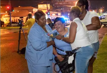  ?? MATTHEW HINTON/THE ADVOCATE VIA AP ?? People react at the scene of a shooting in New Orleans, on Saturday night.