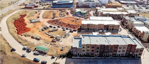  ?? [PHOTO PROVIDED] ?? TOP: The Hill overlookin­g Deep Deuce and Bricktown is almost half complete with developmen­t of the 150-home neighborho­od set to finish in about three years. This photo was taken earlier this month looking south.