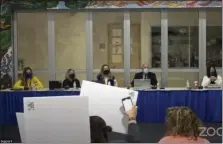  ?? IMAGE FROM SCREENSHOT ?? Members of the audience at Tuesday night’s Spring-Ford meeting shout and wave signs as School Board President Margaret Wright informs them if they do not wear masks, the meeting will be adjourned.