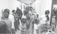  ??  ?? Robinson students and family navigate the hallway at Holland Middle School on Wednesday to find their new classrooms.