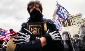  ?? Photograph: John Minchillo/AP ?? A man holds a Bible as Trump supporters gather outside the Capitol in Washington on 6 January 2021.