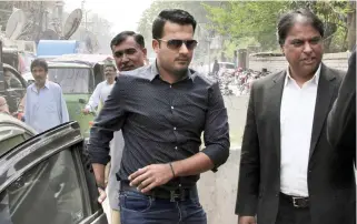  ??  ?? Sharjeel Khan, center, arrives at the office of Federal Investigat­ion Authority for recording his statements in Lahore in this March 21 file photo. (AP)