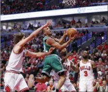  ?? CHARLES REX ARBOGAST — THE ASSOCIATED PRESS ?? The Celtics’ Avery Bradley, center, drives between Bulls’ defenders on Sunday.