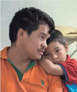  ?? CASEY JACKSON/ USA TODAY NETWORK ?? Genin Rodas, 29, and son Edison, 5, from Saba, Honduras, wait for a family member to buy them a bus ticket after being released by U.S. immigratio­n officials at the Catholic Charities of the Rio Grande Valley refugee center in McAllen, Texas.