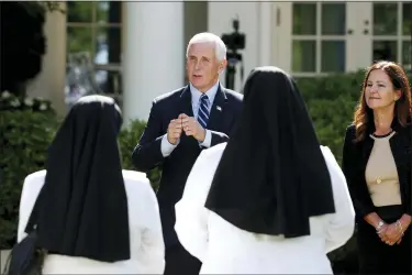  ?? ALEX BRANDON — THE ASSOCIATED PRESS ?? Vice President Mike Pence and his wife Karen Pence speak to attendees after a White House National Day of Prayer Service in the Rose Garden of the White House, Thursday, May 7, in Washington.