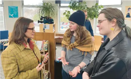  ?? CHRIS WILLIAMS/EDUCATION MINNESOTA ?? Shae Ross, 18, center, joins Minnesota Lt. Gov. Peggy Flanagan, left, at an event opposing book bans March 21 in St. Paul.