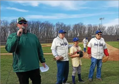  ?? PHOTO COURTESY OF TOM PATTON ?? Tom Patton, right, alongside Michael Lau, second from right, and Bill Wilson are announced to the crowd by Twin Valley athletic director John Guiseppe, left, before throwing out ceremonial first pitches ahead of the Raiders’ Throwback Game on April 8.