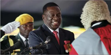  ?? PHOTO/BEN CURTIS ?? Emmerson Mnangagwa (center) is sworn in as President at the presidenti­al inaugurati­on ceremony in the capital Harare, Zimbabwe on Friday. Mnangagwa is being sworn in as Zimbabwe’s president after Robert Mugabe resigned on Tuesday, ending his 37-year...