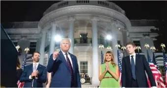  ??  ?? President Donald Trump, flanked by Donald Trump Jr., first lady Melania Trump and Barron Trump, stands on the South Lawn of the White House on the final day of the Republican National Convention on Aug. 27.