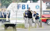  ?? WIN MCNAMEE/GETTY IMAGES ?? Investigat­ors from the FBI look for evidence in a parking lot next to Eugene Simpson Field, the site where a gunman opened fire Wednesday in Alexandria, Va.