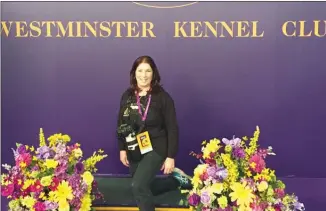  ?? Special to The Daily Courier ?? Summerland photograph­er Sandy Steck poses with her gear last week at the Westminste­r Kennel Club Dog Show in New York.