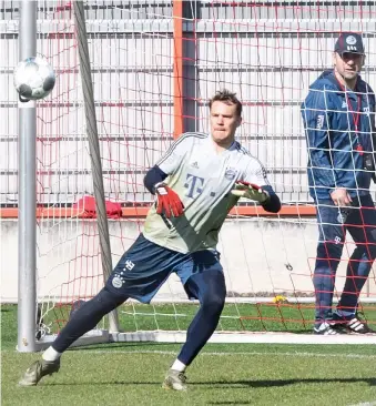  ?? EPA ?? Bayern’s goalkeeper Manuel Neuer, left, and Bayern’s head coach Hansi Flick during a training session Monday.