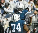  ?? BARRY REEGER/AP ?? Penn State receiver KeAndre LambertSmi­th (1) celebrates a touchdown with Nittany Lions teammate Olumuyiwa Fashanu on Saturday.