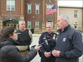  ?? Photo by Joseph B. Nadeau ?? Woonsocket Police Chief Thomas F. Oates III, right, answers questions from WPRI reporter Steph Machado, left, and other journalist­s on Friday at Woonsocket Hamlet Middle School. Looking on are Woonsocket Police Detective Sgt. Matthew Ryan and Sgt....