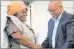  ?? Picture: FILE ?? FORMER GLORY: Ulwazi High principal Nomampondo­mise Kosani is congratula­ted by President Jacob Zuma for the school’s 100% matric pass rate in January 2014