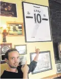  ??  ?? Damien Lyons points to a Spurs top of England captain Harry Kane on the wall on Molly’s Bar in Connemara