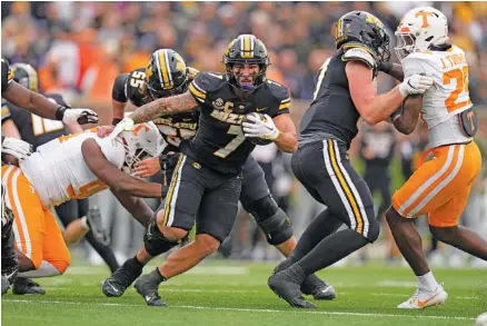  ?? AP PHOTO/JEFF ROBERSON ?? Missouri running back Cody Schrader breaks into the open field during Saturday’s victory over Tennessee at Faurot Field. Schrader rushed for 205 yards and a touchdown on 35 carries. He also had five catches for 116 yards.