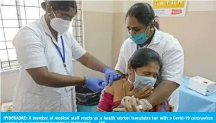  ??  ?? HYDERABAD: A member of medical staff reacts as a health worker inoculates her with a Covid-19 coronaviru­s vaccine at a government hospital in Hyderabad. — AFP