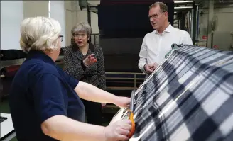  ??  ?? Local producers: Theresa May chats to staff at the Alex Begg factory in Ayr