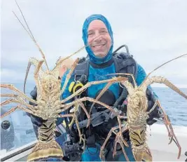  ?? STEVE WATERS/STAFF ?? Ken Udell with two of the lobsters he caught on a recent, well-planned dive trip on Mathie's boat Chiefy out of Hillsboro Inlet.