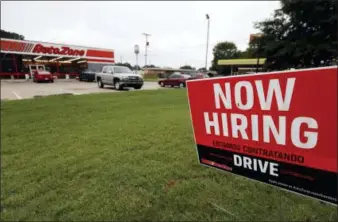  ?? ROGELIO V. SOLIS — THE ASSOCIATED PRESS FILE ?? A bilingual help wanted sign for Auto Zone, a retailer of aftermarke­t automotive parts and accessorie­s, is posted outside the store in Canton, Miss.