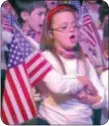  ??  ?? Richboro Elementary School second-grader MacKenzie Patterson sings, “This Land is Your Land” during the school’s annual Patriotism Day.