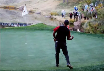  ?? Locher
AP Photo/John ?? In this 2018 file photo, Tiger Woods celebrates after making a chip into the 17th hole during a golf match against Phil Mickelson at Shadow Creek golf course in Las Vegas.