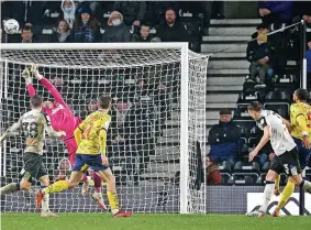  ?? ?? Derby County keeper Ryan Allsop makes a superb save in the closing stages to deny Kyle Bartley (far right) and make sure Wayne Rooney’s men bagged all three points.
