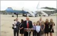  ?? ANDREW HARNIK — THE ASSOCIATED PRESS ?? President Donald Trump speaks about healthcare at Cincinnati Municipal Lunken Airport in Cincinnati, Ohio, on Wednesday. With him are PlayCare co-owner Rays Whalen, left, and CSS Distributi­on Group President Dan Withrow and their families.