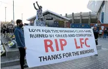  ?? GETTY IMAGES ?? Fans hold up a banner in protest against the European Super League outside the stadium prior to the Premier League match between Leeds United and Liverpool at Elland Road yesterday.