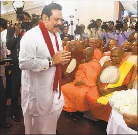  ?? Ishara S. Kodikara AFP/Getty Images ?? MAHINDA RAJAPAKSA, a polarizing former strongman, offers prayers after a ceremony Monday at which he assumed the duties of Sri Lankan prime minster.