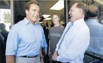  ?? Paul Sakuma Associated Press ?? GOV. ARNOLD SCHWARZENE­GGER, left, with George “Duf” Sundheim, then-chairman of the state GOP, in July 2006. Sundheim’s allegiance to Schwarzene­gger, a polarizing figure within the party, caused friction.