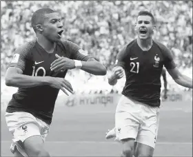  ?? AP/DAVID VINCENT ?? France’s Kylian Mbappe (left) celebrates with teammate Lucas Hernandez after scoring his side’s third goal against Argentina on Saturday during the 2018 World Cup at the Kazan Arena in Kazan, Russia.