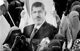  ?? AMR NABIL/ASSOCIATED PRESS ?? A poster of former President Mohammed Morsi was held during at a rally near Cairo on Friday.