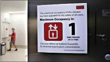  ??  ?? A man decides to take the stairs as a sign states that only one rider at a time is permitted on an elevator due to the COVID-19 virus outbreak July 23 at Boston University in Boston. Dozens of U.S. colleges are announcing plans to test students for the coronaviru­s this fall, but their strategies vary widely. Federal health officials discourage widespread testing on college campuses, but some researcher­s say it's necessary to prevent outbreaks. (AP Photo/ Charles Krupa)