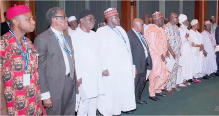  ?? Photo Felix Onigbinde ?? Newly appointed Code of Conduct members take their oath of office during a swearing-in ceremony before President Muhammadu Buhari at the Presidenti­al Villa in Abuja yesterday