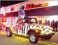  ?? Photo by Randy Moll ?? A Little Debbie Zebra Cakes zebra made an appearance in the annual Gentry Chamber of Commerce Christmas Parade on Saturday.