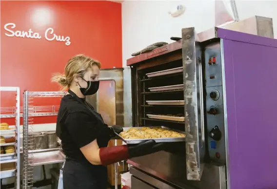  ?? PHOTOS BY LAURA MORTON ?? A fresh batch of cookies is put in the oven at the Pacific Cookie Company, which has been in business for over 40 years. Cookies are baked fresh throughout the day.