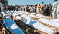  ??  ?? Mourners attend the funeral of 43 farm workers in Zabarmari, Nigeria, on Sunday. (AFP)