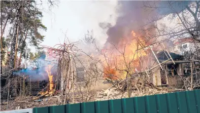  ?? MARCUS YAM/LOS ANGELES TIMES ?? A home is destroyed in a fire Saturday in Irpin, Ukraine, after being bombarded by Russian forces.