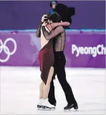  ?? PAUL CHIASSON THE CANADIAN PRESS ?? Tessa Virtue and Scott Moir embrace at the conclusion of their gold-medal free dance.